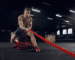 young-healthy-man-athlete-doing-exercise-with-ropes-gym